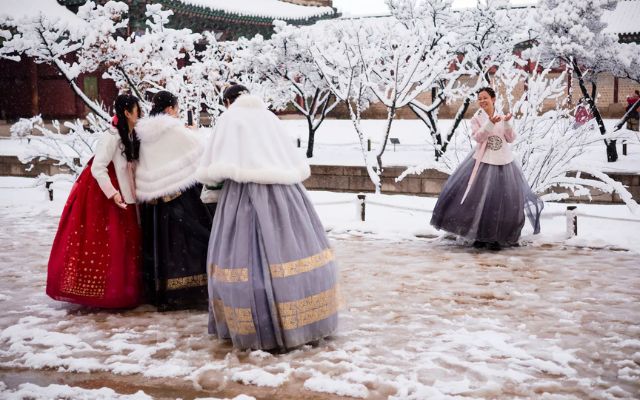 Tourists in hanbok take pictures at Gyeongbokgung Palace